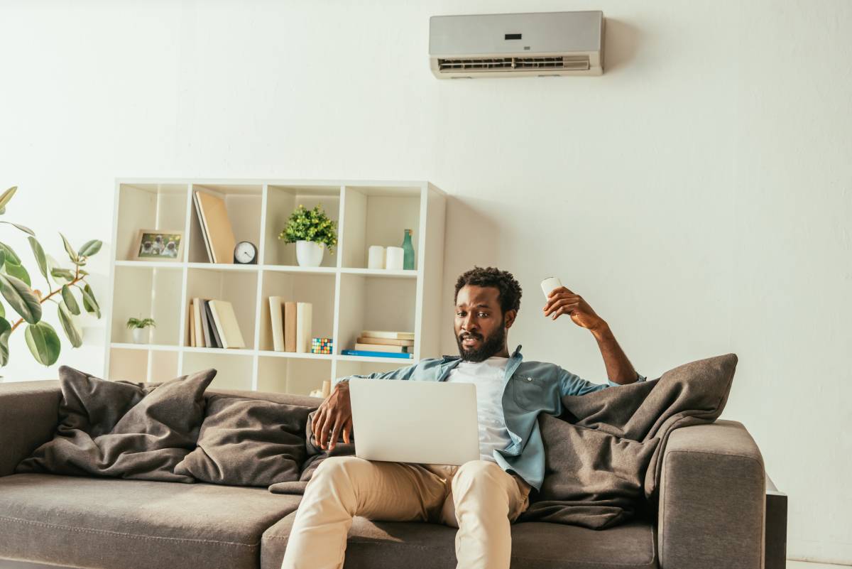 handsome-african-man-using-laptop-while-sitting-on-2024-11-17-09-23-47-utc (1)