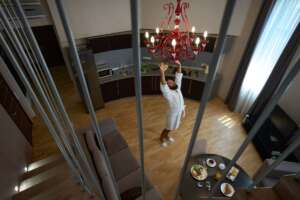 Male in bathrobe enjoys the morning in cozy hotel room